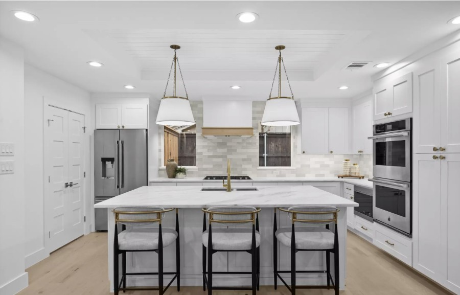 White Kitchen with Double Ovens and Island Seating