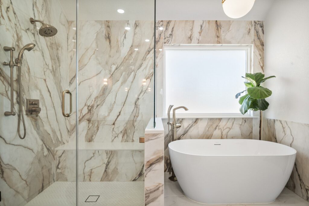 Marble primary bathroom with a freestanding tub and glass shower