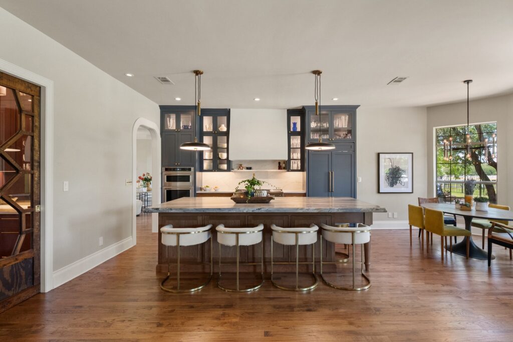 Kitchen with blue-gray glass cabinets and a wood island