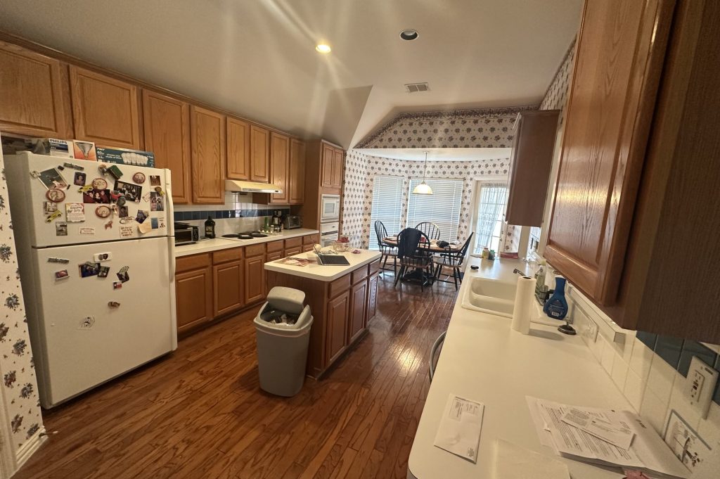 Traditional U-Shaped Kitchen with Oak Cabinets and Floral Wallpaper